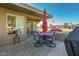 Comfortable patio with table and chairs under an umbrella, perfect for outdoor dining and relaxation at 25225 S Glenburn Dr, Sun Lakes, AZ 85248