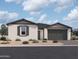 Charming single-story home with a two-car garage, desert landscaping, and neutral stucco facade at 26370 N 77Th Dr, Peoria, AZ 85383