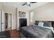Bright bedroom featuring wood floors, a ceiling fan, and natural light at 27023 N 130Th Gln, Peoria, AZ 85383