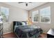 Cozy bedroom with a ceiling fan, wood floors, and multiple windows for natural light at 27023 N 130Th Gln, Peoria, AZ 85383