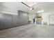 Spacious garage featuring ample storage with custom cabinets and epoxy flooring at 27023 N 130Th Gln, Peoria, AZ 85383