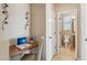 Home office featuring a built in desk and a view to a nearby bathroom at 27023 N 130Th Gln, Peoria, AZ 85383