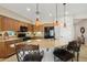 Spacious kitchen featuring a granite countertop island with chairs and stainless steel appliances at 27023 N 130Th Gln, Peoria, AZ 85383