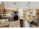 Bright kitchen with a granite countertop island, stainless steel appliances, and pendant lighting at 27023 N 130Th Gln, Peoria, AZ 85383