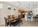 Spacious kitchen features custom cabinetry, countertops, pendant lighting and adjoining dining area at 27023 N 130Th Gln, Peoria, AZ 85383