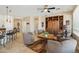 Bright living room with a ceiling fan, tile flooring, and built-in shelving unit at 27023 N 130Th Gln, Peoria, AZ 85383