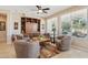 Spacious living room featuring built-in shelving, large windows, and comfortable seating at 27023 N 130Th Gln, Peoria, AZ 85383