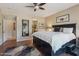 Comfortable main bedroom with a large bed, ceiling fan, and access to the bathroom at 27023 N 130Th Gln, Peoria, AZ 85383