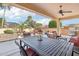 Inviting covered patio showcasing a dining table and chairs, plus relaxing outdoor seating at 27023 N 130Th Gln, Peoria, AZ 85383