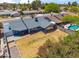 Aerial view of backyard featuring a grass lawn, covered patio, and partial view of neighborhood and pool at 2708 E Villa Theresa Dr, Phoenix, AZ 85032