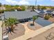 This aerial shot presents a home with desert landscaping, xeriscaping, and a blue painted exterior at 2708 E Villa Theresa Dr, Phoenix, AZ 85032