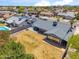 Spacious backyard with a well-maintained lawn, privacy fence, patio, and pool visible in this aerial view at 2708 E Villa Theresa Dr, Phoenix, AZ 85032