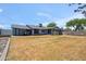 Large backyard with green grass, mature trees, and a view of the house exterior at 2708 E Villa Theresa Dr, Phoenix, AZ 85032