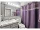 Cozy bathroom with lavender accents, sink, toilet, mirror, and shower at 2708 E Villa Theresa Dr, Phoenix, AZ 85032