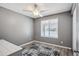 This bedroom offers a neutral color scheme and laminate flooring with a window and a ceiling fan at 2708 E Villa Theresa Dr, Phoenix, AZ 85032