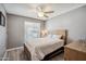 Cozy bedroom featuring a queen-size bed with plush bedding and a wooden nightstand at 2708 E Villa Theresa Dr, Phoenix, AZ 85032