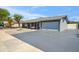 Charming single-story home featuring a large driveway, well-kept yard and a delightful front porch swing at 2708 E Villa Theresa Dr, Phoenix, AZ 85032