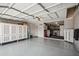 Spacious garage with storage cabinets and epoxy flooring, perfect for organization and vehicle storage at 2708 E Villa Theresa Dr, Phoenix, AZ 85032