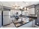Modern kitchen featuring stainless appliances, mosaic backsplash, ample counter space, and natural light at 2708 E Villa Theresa Dr, Phoenix, AZ 85032