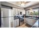 Well lit kitchen with stainless steel appliances and gray cabinetry at 2708 E Villa Theresa Dr, Phoenix, AZ 85032