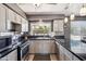 Charming kitchen with gray cabinets, dark countertops, and stainless appliances at 2708 E Villa Theresa Dr, Phoenix, AZ 85032