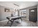 Inviting living room featuring a pool table, wood-look floors, neutral paint, and natural light at 2708 E Villa Theresa Dr, Phoenix, AZ 85032