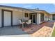Charming patio features a brick floor, an outdoor dining set, and access to both the house and backyard at 2708 E Villa Theresa Dr, Phoenix, AZ 85032