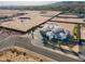 Expansive aerial view of luxury home, large lot, circular driveway, and mountain views at 3518 N 201St Ln, Buckeye, AZ 85396