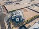 Aerial view showcasing modern house, circular driveway, mature landscaping, and spacious lot at 3518 N 201St Ln, Buckeye, AZ 85396