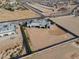 An aerial view of luxury property on a large desert lot with neighborhood in distance at 3518 N 201St Ln, Buckeye, AZ 85396