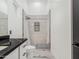 Contemporary bathroom with marble floors, stand up shower and dark countertop at 3518 N 201St Ln, Buckeye, AZ 85396