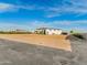 Expansive property featuring a modern home with light colored exterior paint and ample space for future landscaping at 3518 N 201St Ln, Buckeye, AZ 85396