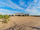 View of a modern home with clean lines, light exterior and desert landscaping in a spacious setting at 3518 N 201St Ln, Buckeye, AZ 85396