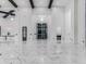 Grand foyer featuring high ceilings, marble floors, modern lighting, and custom entry door at 3518 N 201St Ln, Buckeye, AZ 85396