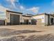 Spacious three-car garage featuring modern doors and sleek design elements at 3518 N 201St Ln, Buckeye, AZ 85396