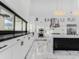 Bright kitchen featuring white cabinets, stainless appliances, with marble countertops and backsplash at 3518 N 201St Ln, Buckeye, AZ 85396
