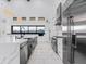 Modern kitchen boasting sleek black island, marble floors, and plenty of counter space with neighborhood view at 3518 N 201St Ln, Buckeye, AZ 85396