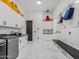 Modern laundry room with washer, dryer, black countertops, cabinets, and convenient seating at 3518 N 201St Ln, Buckeye, AZ 85396