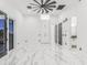 Spacious living room with elegant marble floors and modern ceiling fan at 3518 N 201St Ln, Buckeye, AZ 85396