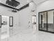 Bright living room featuring high ceilings, modern ceiling fan, and marble flooring at 3518 N 201St Ln, Buckeye, AZ 85396
