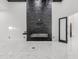 Open living room featuring a modern fireplace and marble floors at 3518 N 201St Ln, Buckeye, AZ 85396