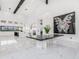 Bright modern living room featuring elegant marble floors and an open kitchen at 3518 N 201St Ln, Buckeye, AZ 85396