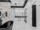 Modern bathroom showcasing a black freestanding tub, dual vanity sinks, and glass-enclosed walk-in shower at 3518 N 201St Ln, Buckeye, AZ 85396