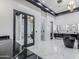 Bright main bathroom featuring sleek black freestanding tub, dual vanities, and tiled walk-in shower at 3518 N 201St Ln, Buckeye, AZ 85396