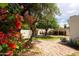 Lush backyard with trees, flowering bushes, and brick path to the covered structure at 356 W Roma Ave, Phoenix, AZ 85013