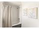 Cozy bathroom featuring a shower with curtain, neutral textures and modern art for a relaxing atmosphere at 356 W Roma Ave, Phoenix, AZ 85013