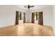 Open bedroom featuring hardwood floors, bright windows, and modern ceiling fan, for a bright atmosphere at 356 W Roma Ave, Phoenix, AZ 85013