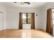 Inviting bedroom with hardwood floors and window offering serene views, plus a modern ceiling fan at 356 W Roma Ave, Phoenix, AZ 85013