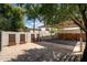 Carport and storage area featuring a concrete driveway, privacy walls, and ample parking space for vehicles at 356 W Roma Ave, Phoenix, AZ 85013