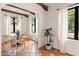 Charming dining area features exposed beams, neutral tones, and natural lighting creating a cozy atmosphere at 356 W Roma Ave, Phoenix, AZ 85013